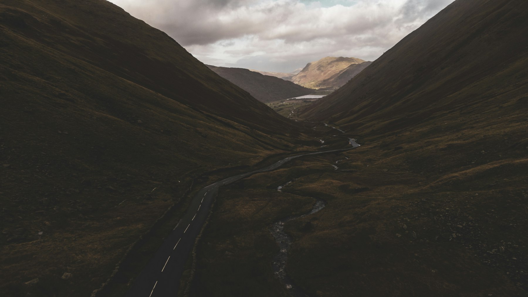 A winding road traversing a mountain valley, traced by a single route line